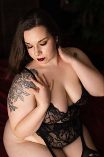 Boudoir photograph of a beautiful curvy woman in sensual black lingerie.