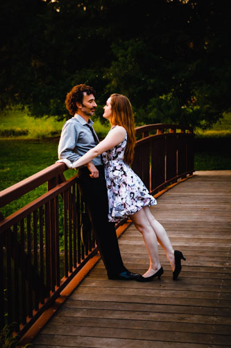 The couple stand toe to toe on the bridge, gazing into each other's eyes. 