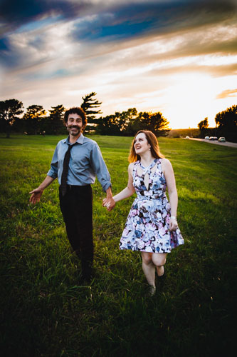Unposed moments like this couple walking through a field, prompted by the photographer, capture genuine laughter and smiles, and help couples overcome nerves of being in front of the camera.