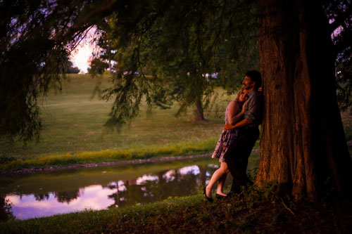Intimate moments showcase a couple's relationship, like this recently engaged couple embracing under a tree.