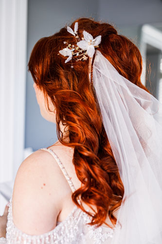 Floral hairpiece and bridal veil in bride's hair